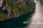 A cruise ship navigates past sheer cliffs in Geirangerfjord-Norway Art Print